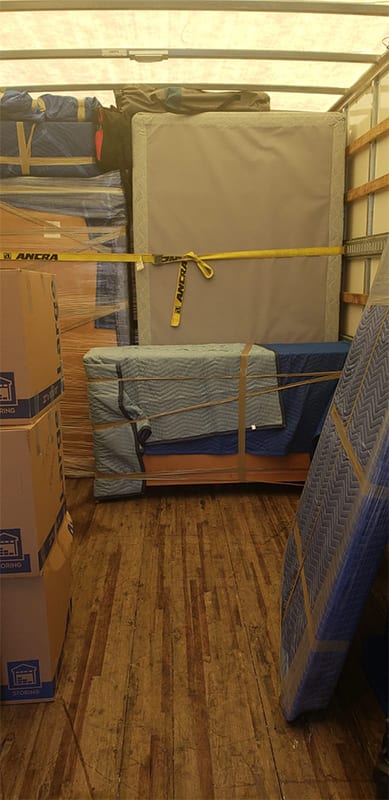Wrapped furniture in enclosed moving trailer